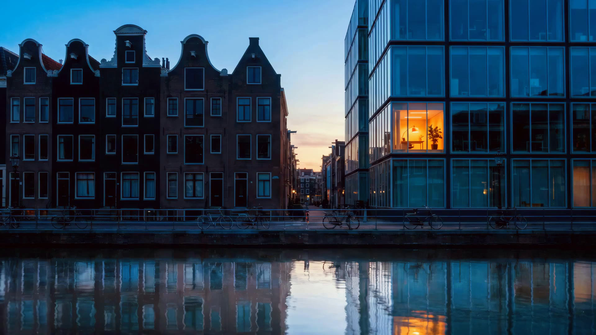 Amsterdam canal at blue hour, one office window lit